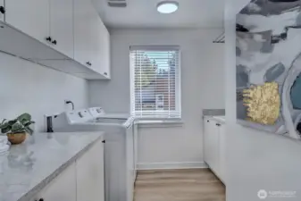 Laundry Room with ample storage, countertop, and sink