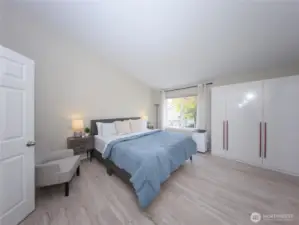 The spacious primary suite features vaulted ceilings, dual closets, and a remodeled bath