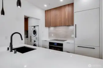 Chef's kitchen with Caeserstone countertops and Dekton Arga stone backsplash!