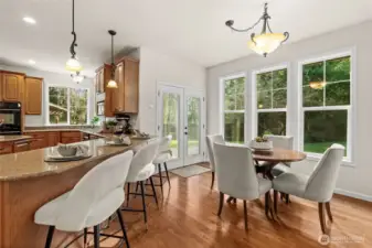 Warm up to the breakfast bar providing a perfect spot for morning beverages, or enjoy some beautiful backyard views at the dining table.