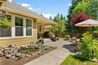 Venture from the primary suite to the back covered patio on your own custom sidewalks.