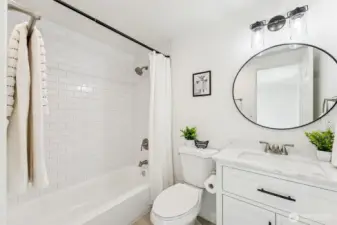 Fully renovated bath with modern fixtures, stylish tilework, and clean lines.
