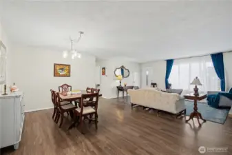 Timeless hardwood style flooring anchors this expansive living dining and living space.