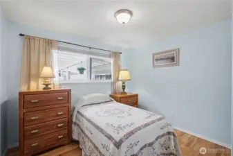 Bright and cozy third bedroom with abundant natural light offering a comfortable and inviting space with flexibility for a variety of uses.