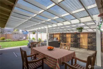 Exceptional covered outdoor living area, perfect for year round enjoyment. Ideal for dining, entertaining, or relaxing while overlooking the private yard.