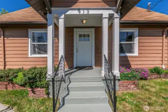 Welcoming front porch greets you as you enter this darling home.