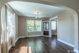 Expansive living room area with hardwood floors that have been refinished.