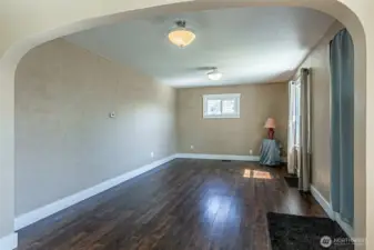 View of living room and front door. Windows have been updated to vinyl for energy efficiency.