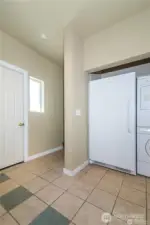 Washer, dryer and 2 extra refrigerators. There are stairs leading to the second level and another side door. Plus a entry door to the right to the garage.