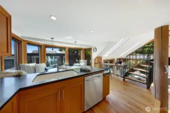 It's pretty brilliant how the kitchen is placed in between the main living spaces and the primary bed and bath to make for an open floor plan without being too open!