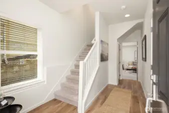The lower level - where you enter through the main door or from the garage - welcomes you with new LVP flooring and fresh paint, including walls, ceilings, doors, and trim. There is a coat closet with additional storage on the way to the home's bonus room.