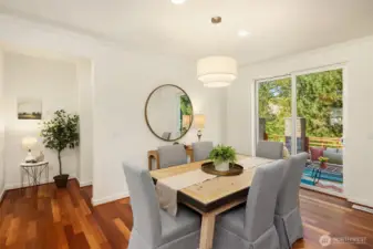 Just behind the eating area is a hallway leading towards the home's powder room. There is a double-door closet in this hallway, providing even more storage. The space you see with the plant could be utilized with open shelving or built-in desk.