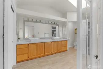 Spacious primary bathroom with a water closet.