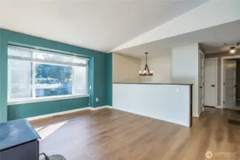 Bright living room with large window overlooking the front yard