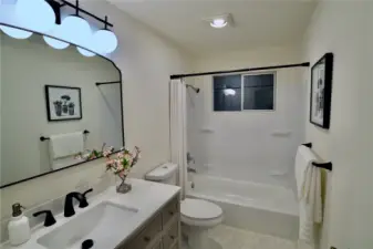 Full bath has new bath tub and surround.