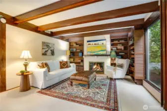 Library end of the family room with beamed ceilings & book shelves surrounding the gas fireplace.  Curl up for a read.
