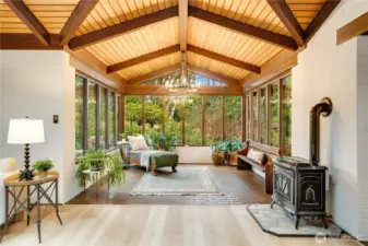 Still in the rec room is a sun room seating area with freestanding gas fireplace.