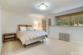 Third bedroom with large landscape window & balcony access.