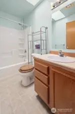 Guest bathroom with shower/tub combo and skylight to really open up the space