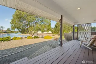Covered back deck invites you to sit down and enjoy the view for a while