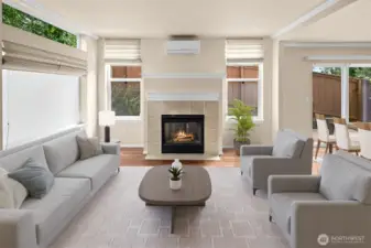 Virtually staged. Another view of the living room with great natural light, gas fireplace and mini-split heating/AC.