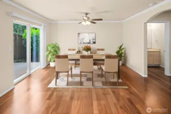 Virtually staged. Ample dining area with large sliding glass door to outdoor garden space and deck.