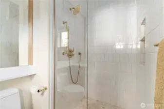 Luxury walk -in shower fully tiled walls and flooring.