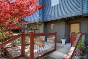 A fenced, hardscaped patio greets you as you approach this fantastic townhome set up off the sidewalk.
