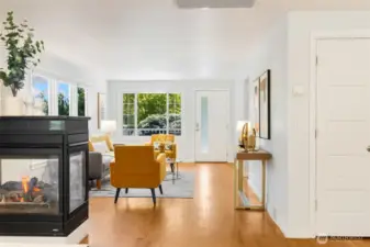 Love the connection between dining room  and living room. Cozy 2-sided gas fireplace  anchors the space.