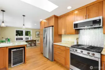 This is a serious (and seriously inspiring!)  kitchen for the home chef: abundant  cabinetry, gas range, wonderful natural light  (LOVE the skylight), and wonderful space to  spread out and create your everyday home  cooking masterpieces! Oh, yes, a wine  fridge for the celebrations.