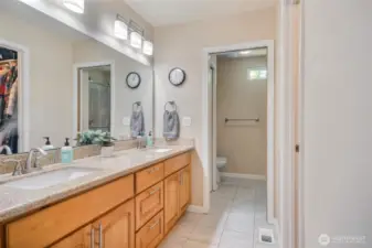 Primary bath with dual vanity, walk-in closet, and 3/4 bath