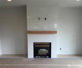 Home as of 06/25/25. Upgraded tile surround to the ceiling at the fireplace.