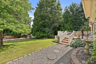 Step down from the deck onto the beautiful grounds, with easy access to the sports court.