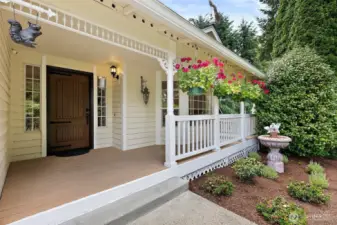 Sit out on your inviting front porch and swing while enjoying the serene views and sounds of the garden water feature.