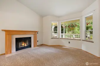 This formal living room overlooks the beautiful landscaped front yard and is flooded with natural light through the bay windows.