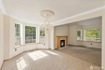 This view of the formal Dining & Living Rooms shows off the beautiful views out the large picture windows. Truly a tranquil setting, on.56 acres...