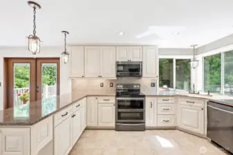 Gourmet kitchen with soft close cabinetry, glass backsplash and modern appliances