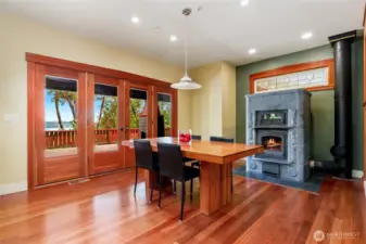 Adjacent to the kitchen, fantastic dining area with great views and beautiful soapstone TUIKIVI fireplace with pizza oven.