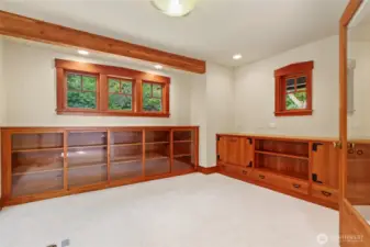 Cherry wood build ins surround this bright beautiful office/ den space.