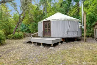 Exterior view of the yurt. There is a nearby woodshed to make keeping warm easy.