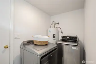 Back downstairs is the laundry area, which connects to the attached garage.