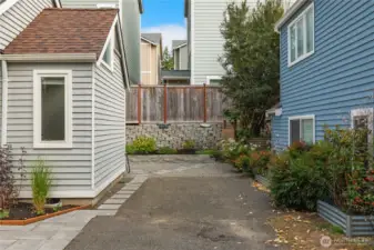 On the east side of the home is a second parking area. This is a dedicated space for this home. You also have a dedicated space in front of your garage.
