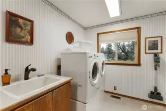 Utility sink with full size front load washer and dryer (included).