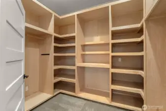 Primary walk-In closet with organizational system.