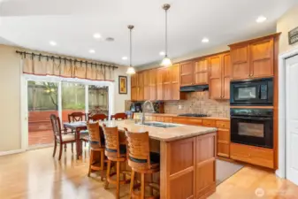 Beautiful cherry wood cabinetry, walk in pantry, large stone topped island with SS sink and dishwasher. A place for everything!