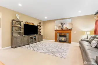 Great room concept with focal gas fireplace and wood mantle. Surround sound.