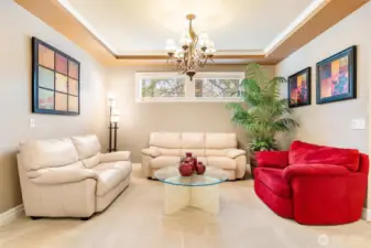 This conversation corner features a classic tray ceiling with chandelier, but this room could also accommodate a formal dining table with hutch and side table.