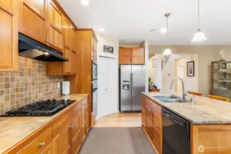Cherry cabinets, gas cooktop, wall oven with microwave above, walk-in pantry, and large island are the ingredients for some fabulous feasts.