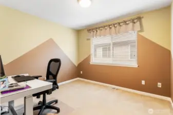 Bedroom with a custom mountain theme is used as a secondary office.
