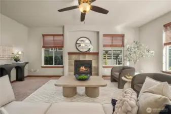 The large living room features lots of windows, flooding the space with natural light.